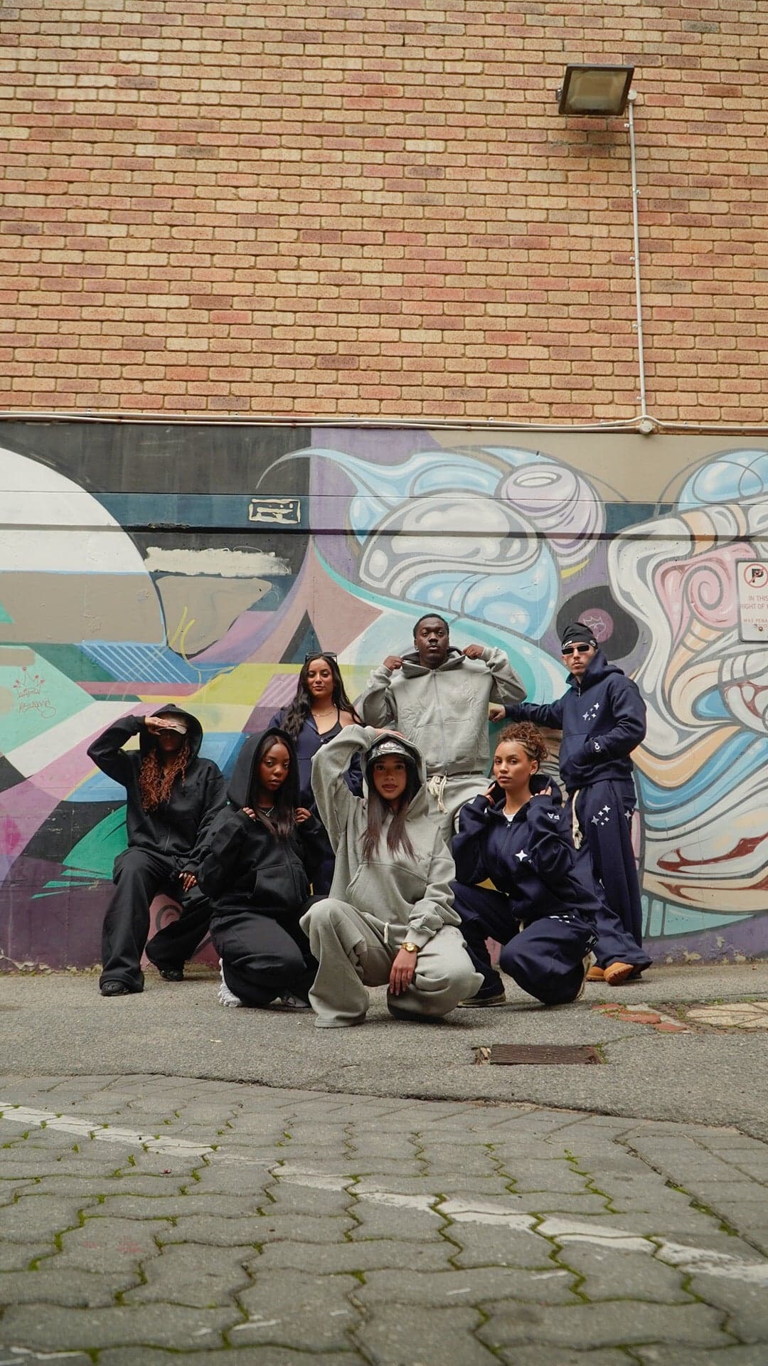 The IOPA community wearing the Ascend collection in a graffiti laneway, Perth